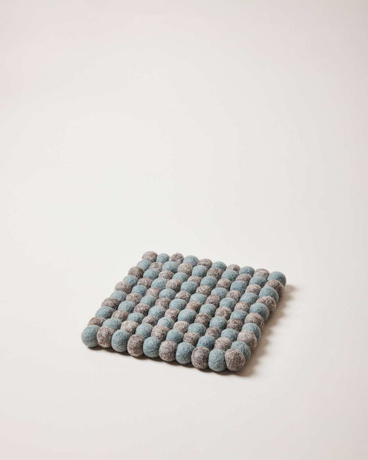 Farmhouse Pottery artisan felt pom pom trivet teal and pebble grey.