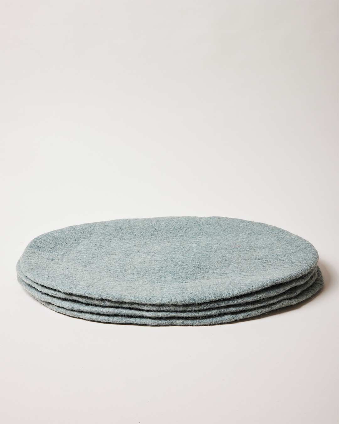 Farmhouse Pottery artisan felt placemats teal.