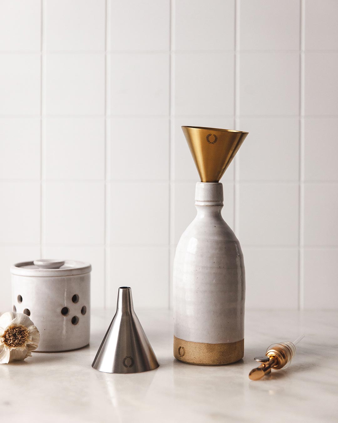stainless steel gold and silver funnel sitting in oil bottle