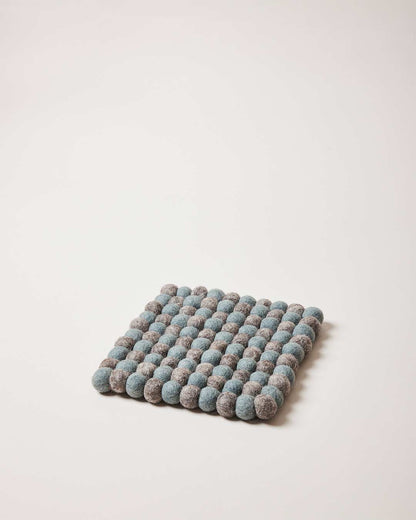 Farmhouse Pottery artisan felt pom pom trivet teal and pebble grey.
