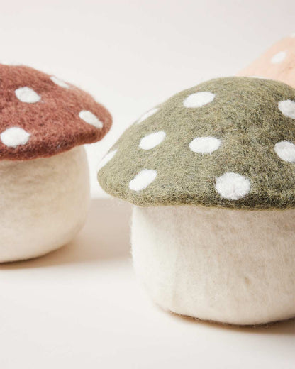 Farmhouse Pottery artisan felted mushroom doorstops in three colors. 