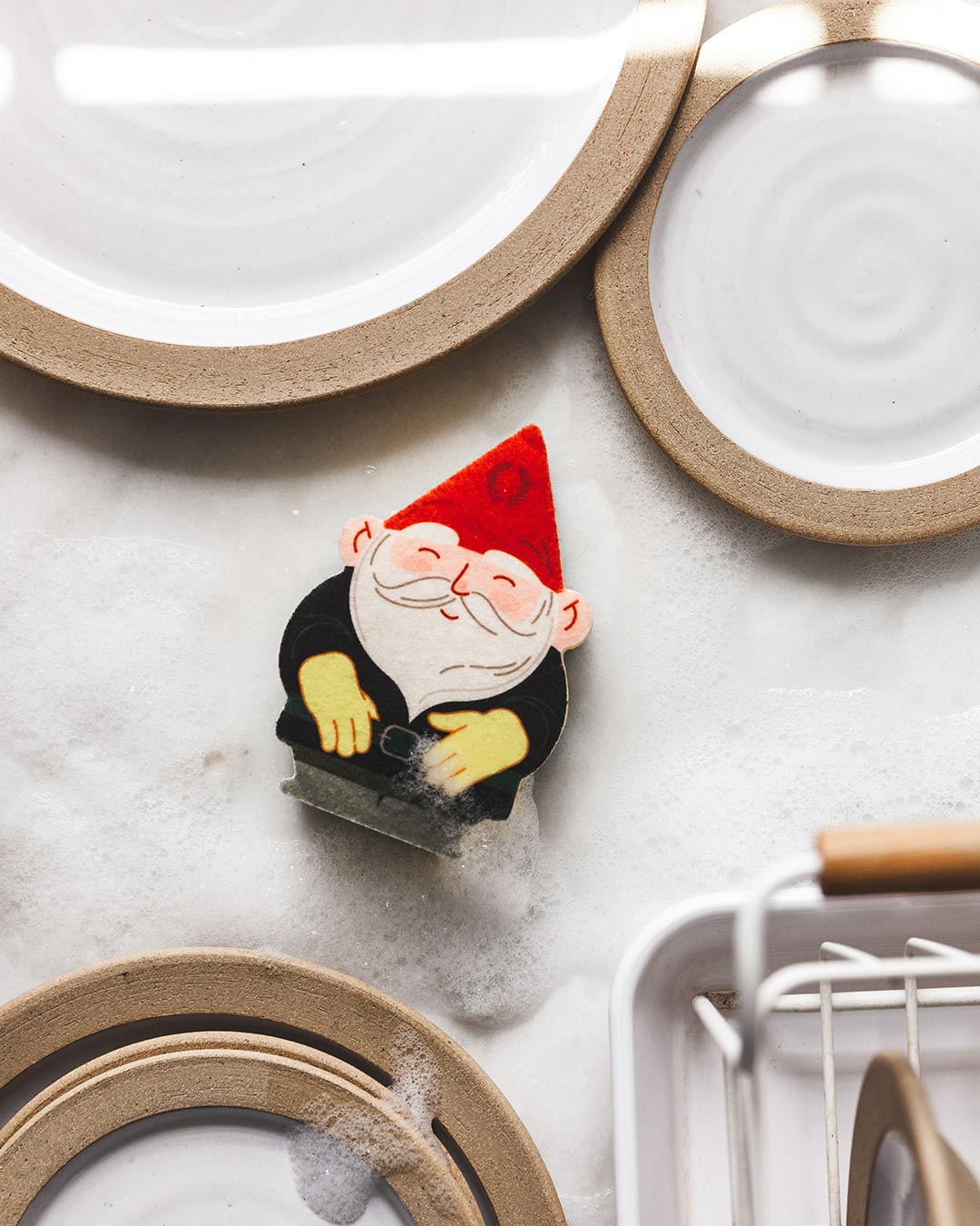 Farmhouse Pottery gnome sponge on countertop. 