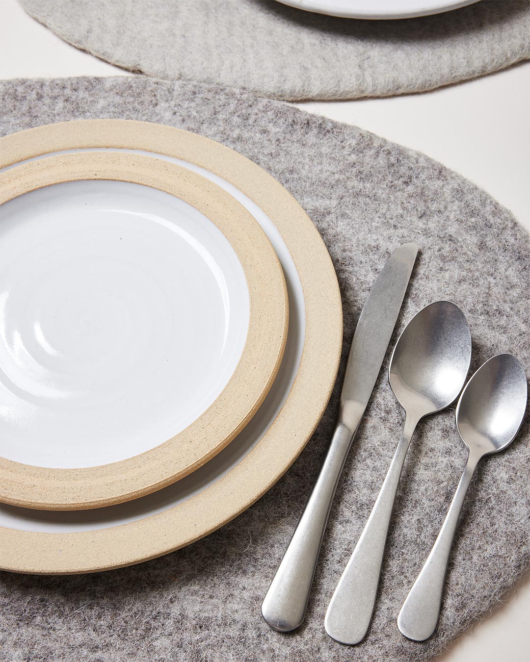 Farmhouse Pottery artisan felt placemats pebble grey with dinner setting. 