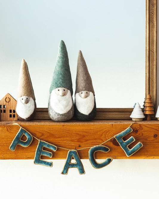 Farmhouse pottery felted woodland gnome in three sizes on mantel.