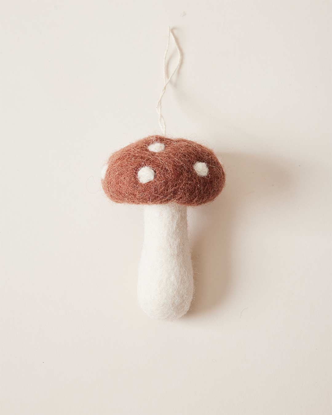 Farmhouse Pottery felted mushroom ornament in brown. 