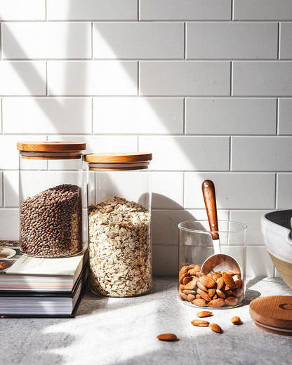 Farmhouse Pottery glass utility canisters on kitchen counter.