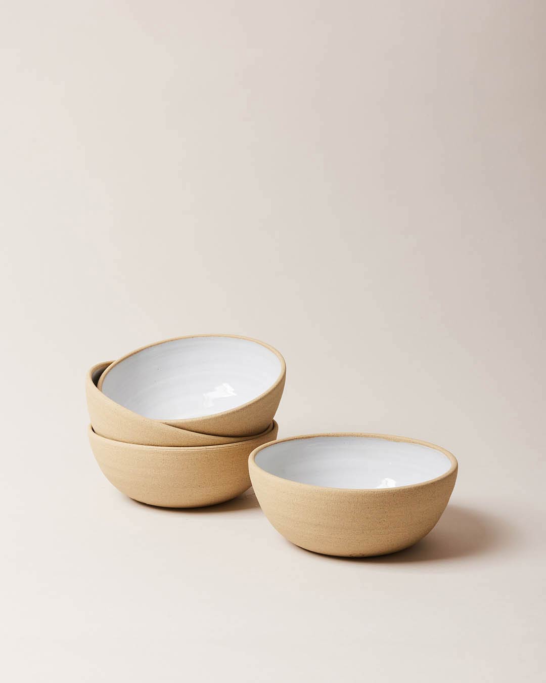 Farmhouse Pottery Harvest Bowl small set of 4 with a light cream background.