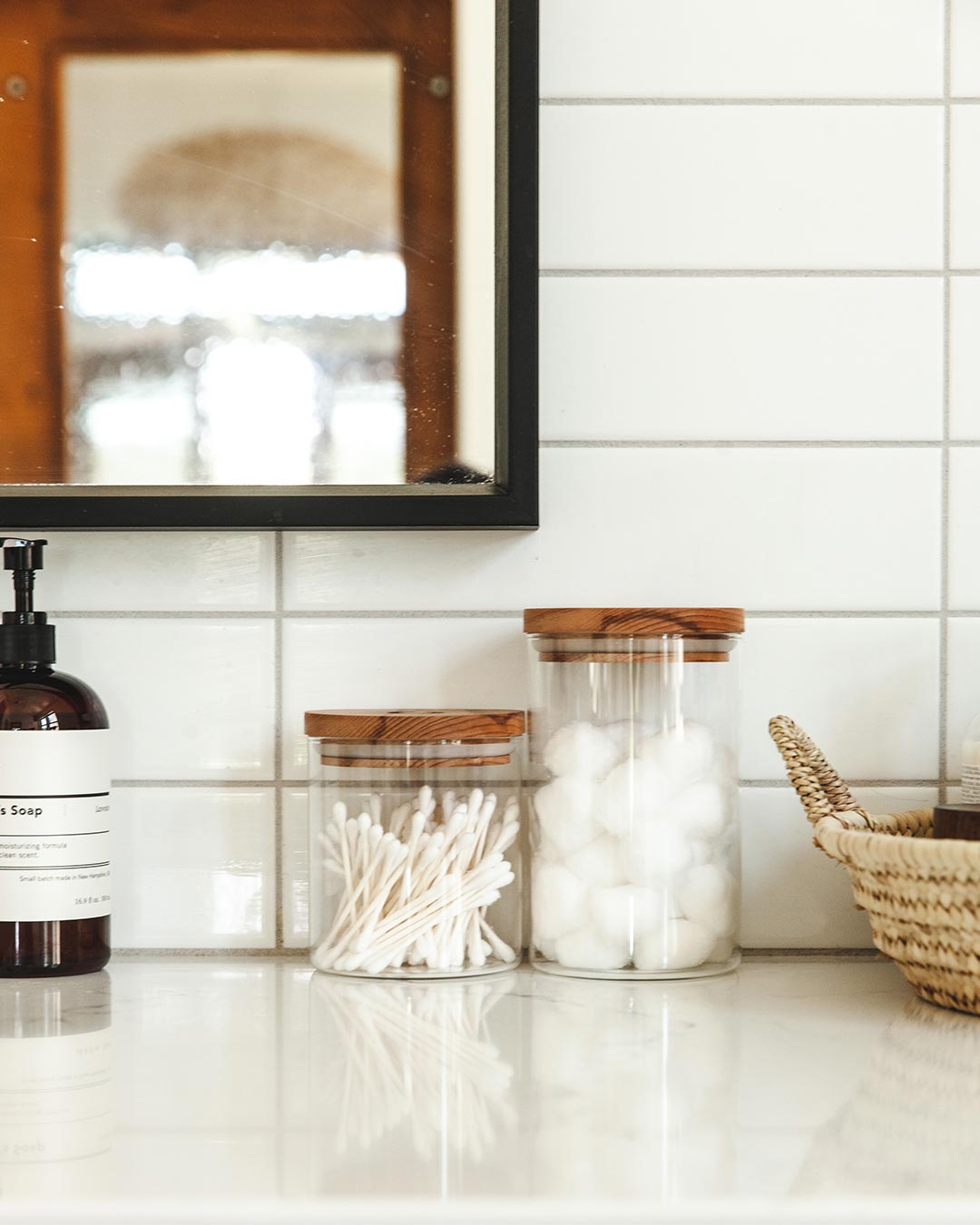 Farmhouse Pottery glass utility canister in bathroom.