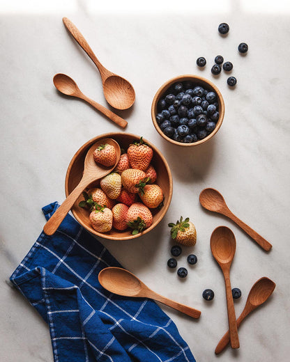 Farmhouse Pottery essential kitchen little spoon set of 7 in beech shown with wooden utility bowls. 